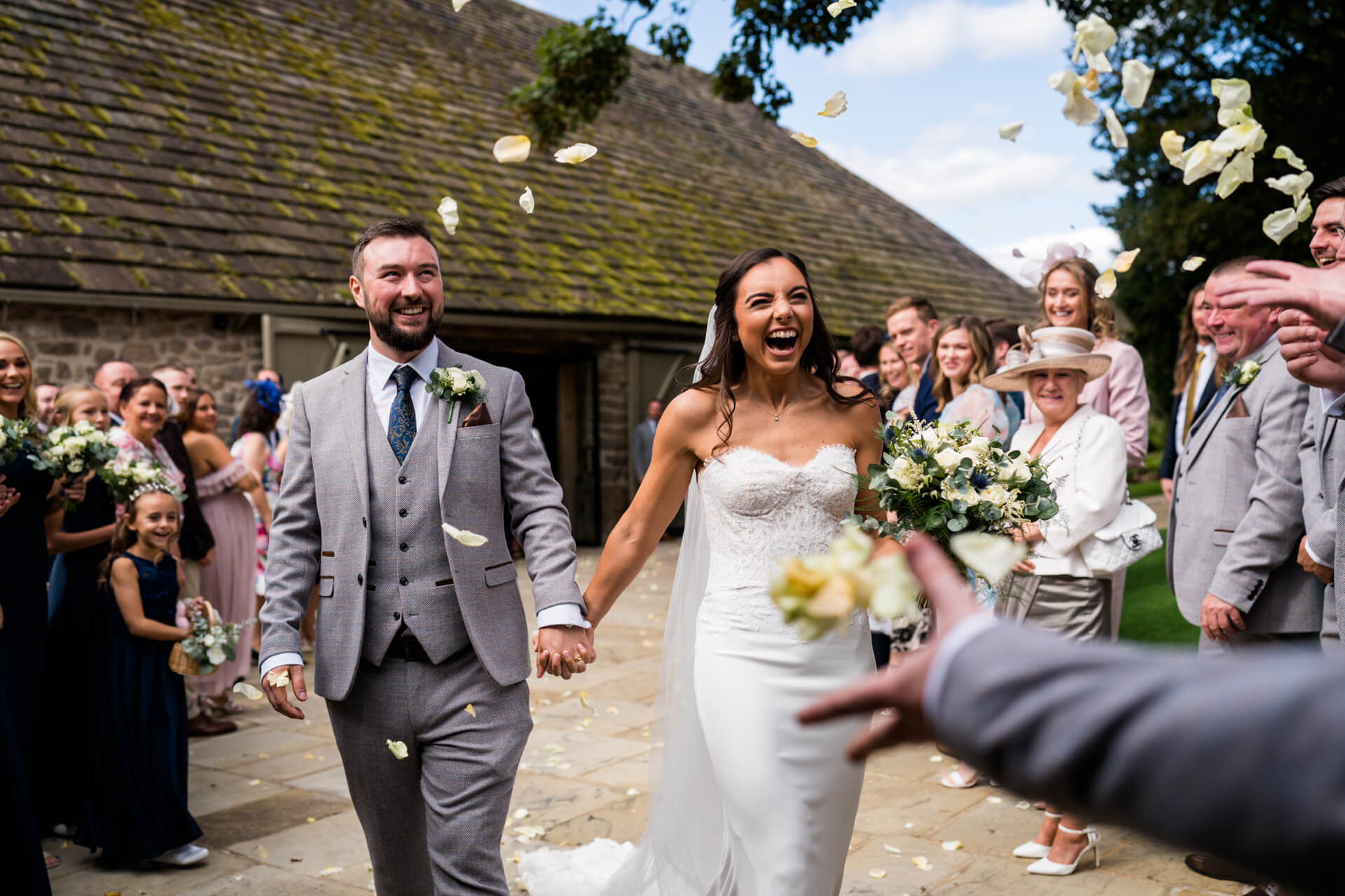 wedding guests shower the couple with confetti at Tithe Barn Bolton Abbey