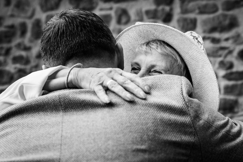 grandma hugs the groom