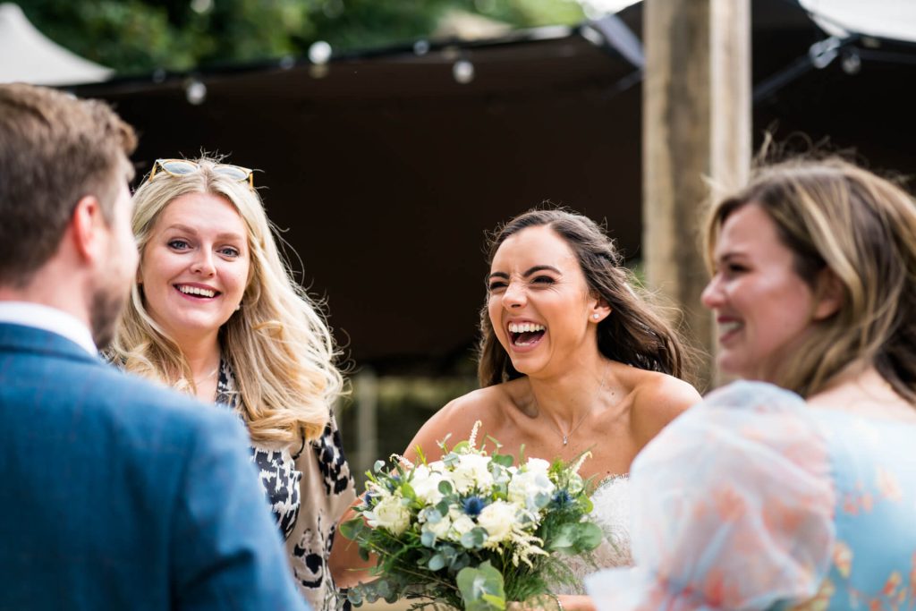bride laughs with a group of friends