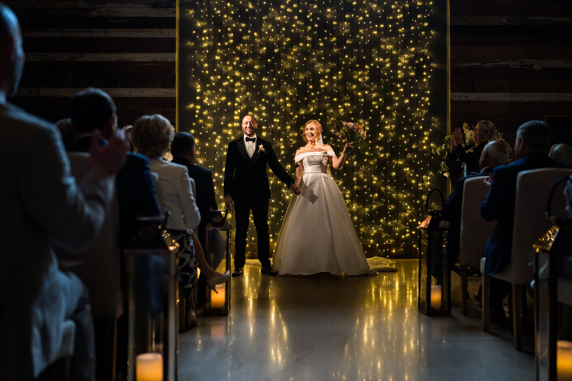 bride and groom cheer as they are about to walk the aisle
