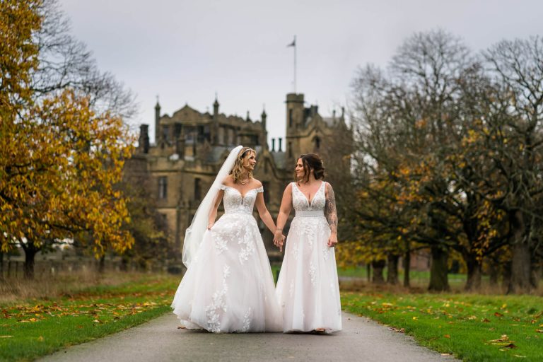 wedding couple walking down the road in front of Allerton Castle