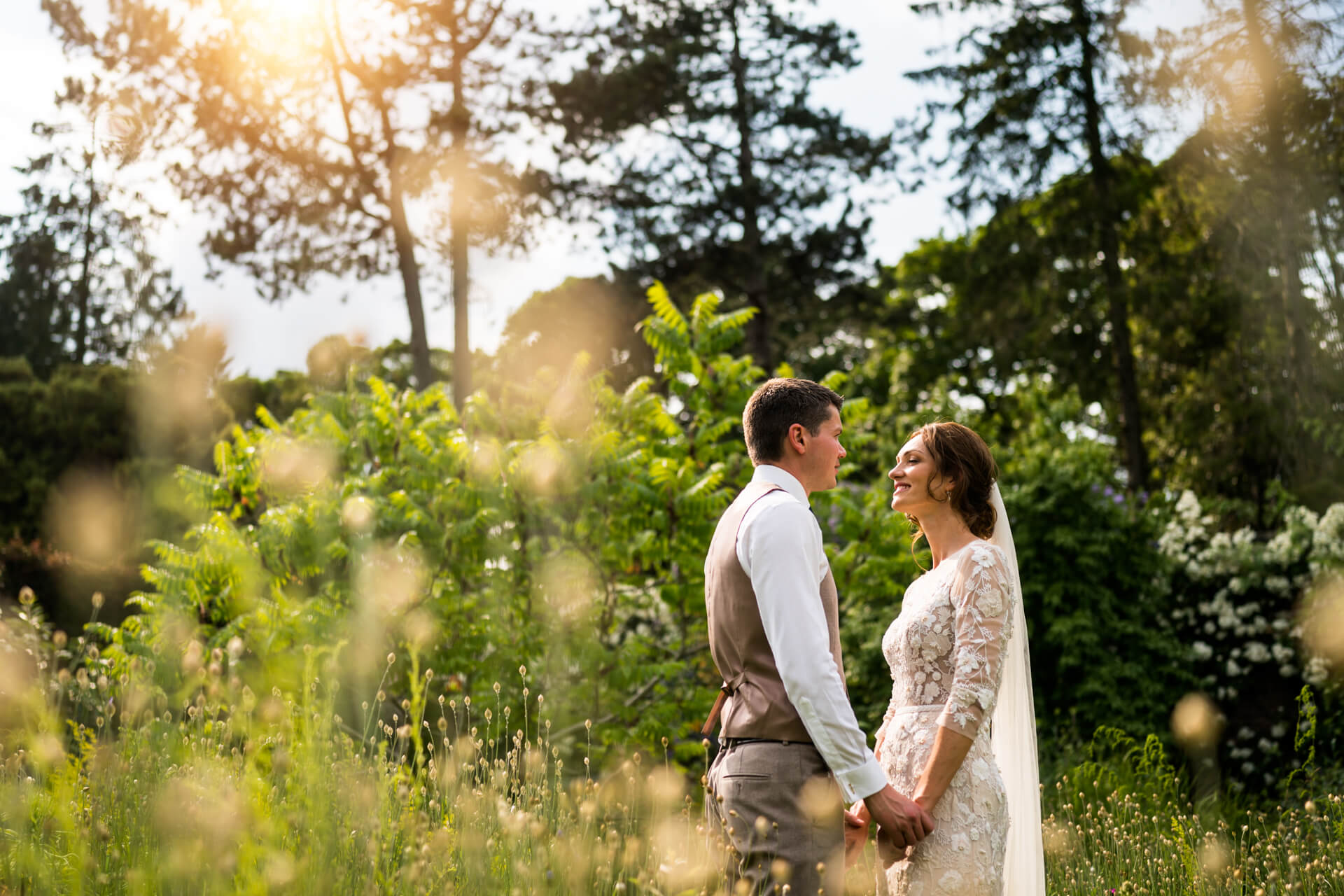 bride and groom holding hands in the gardens at Middleton Lodge