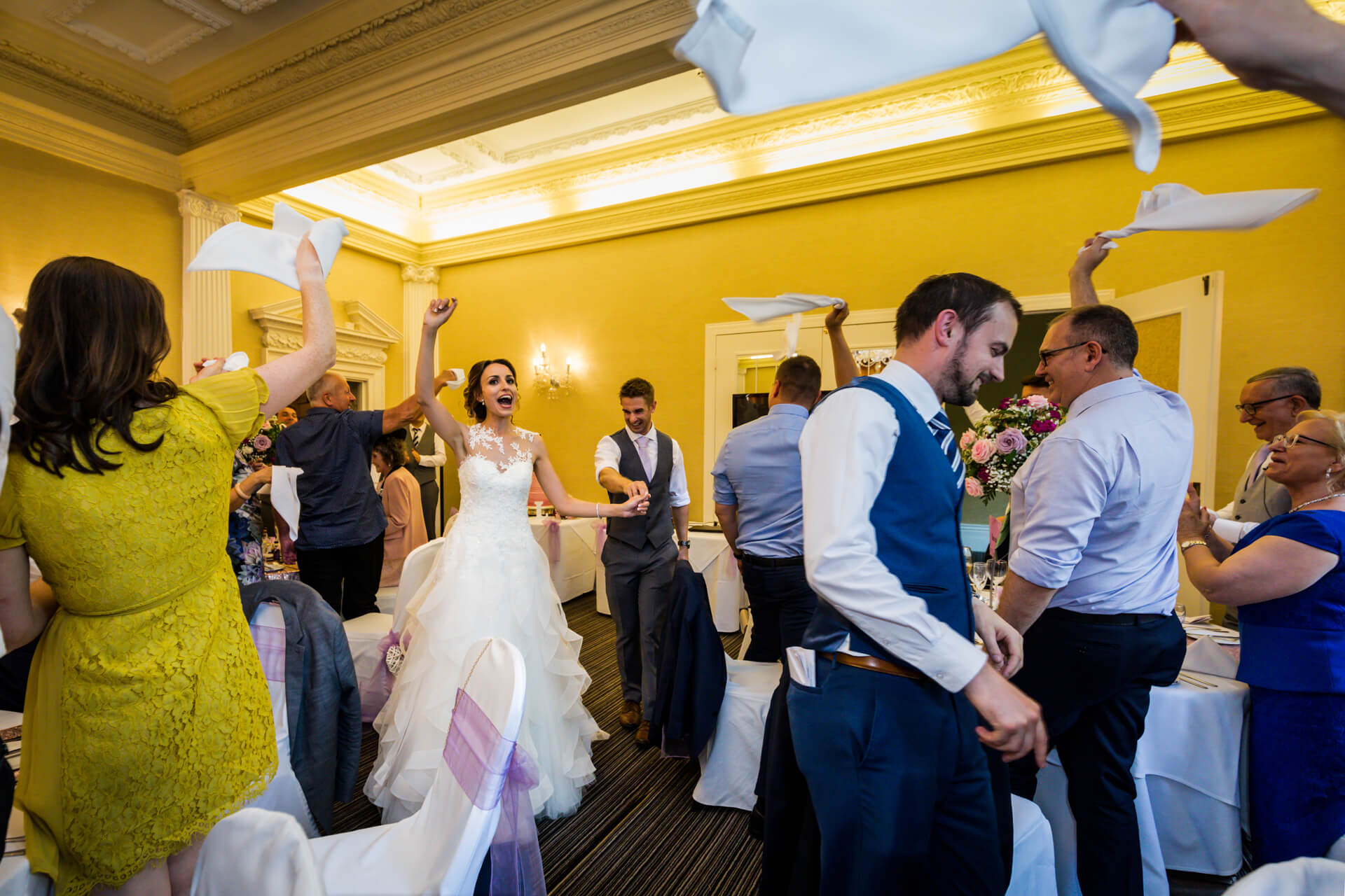 Joyful wedding reception with dancing and napkin tossing at Aldwark Manor