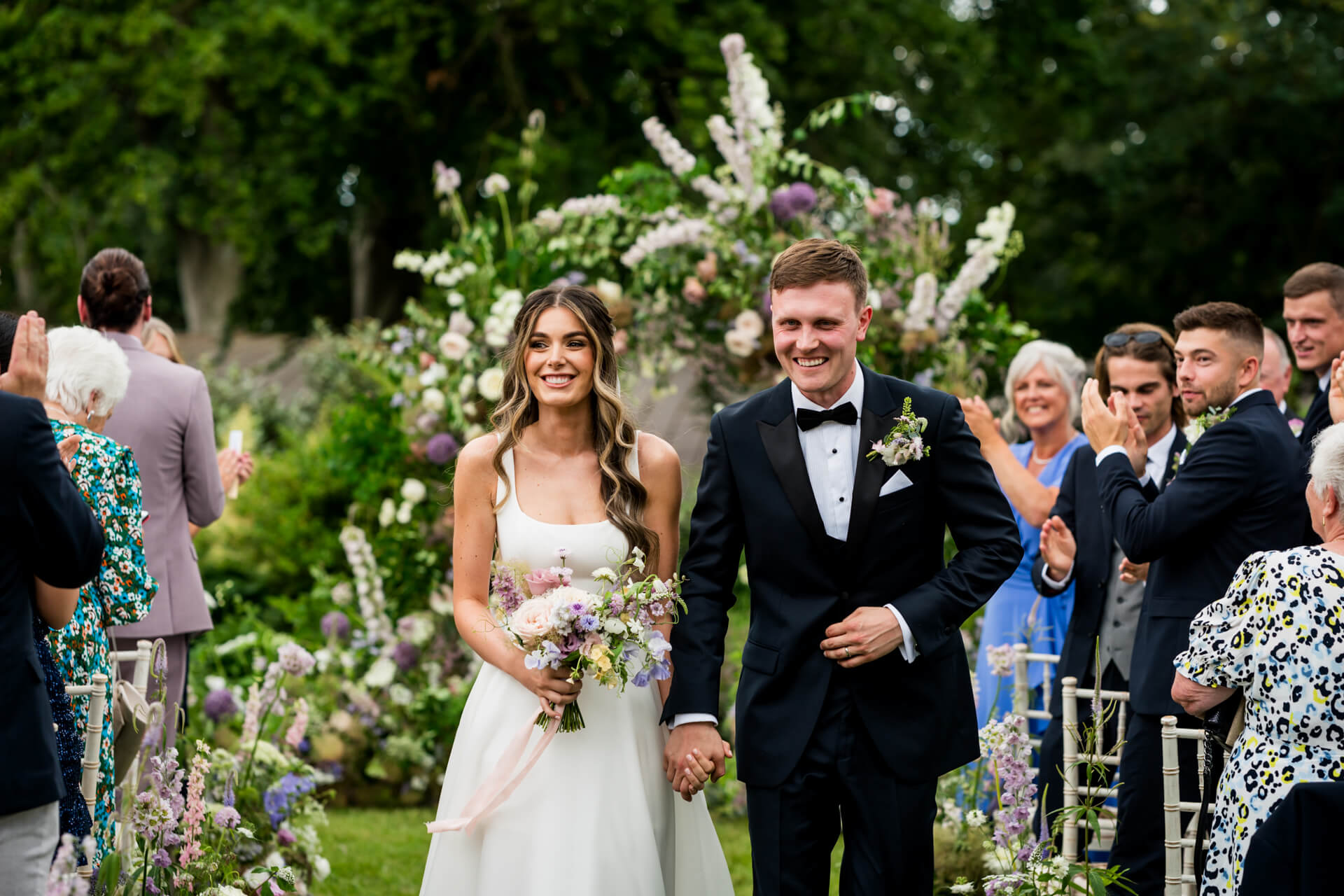 Bride and groom walking down the aisle at Bowcliffe Hall