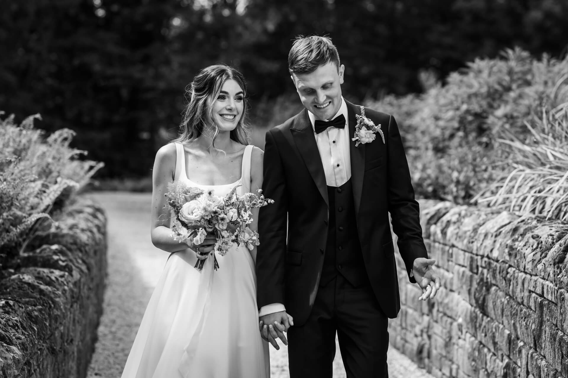 Couple walking hand-in-hand at Bowcliffe Hall