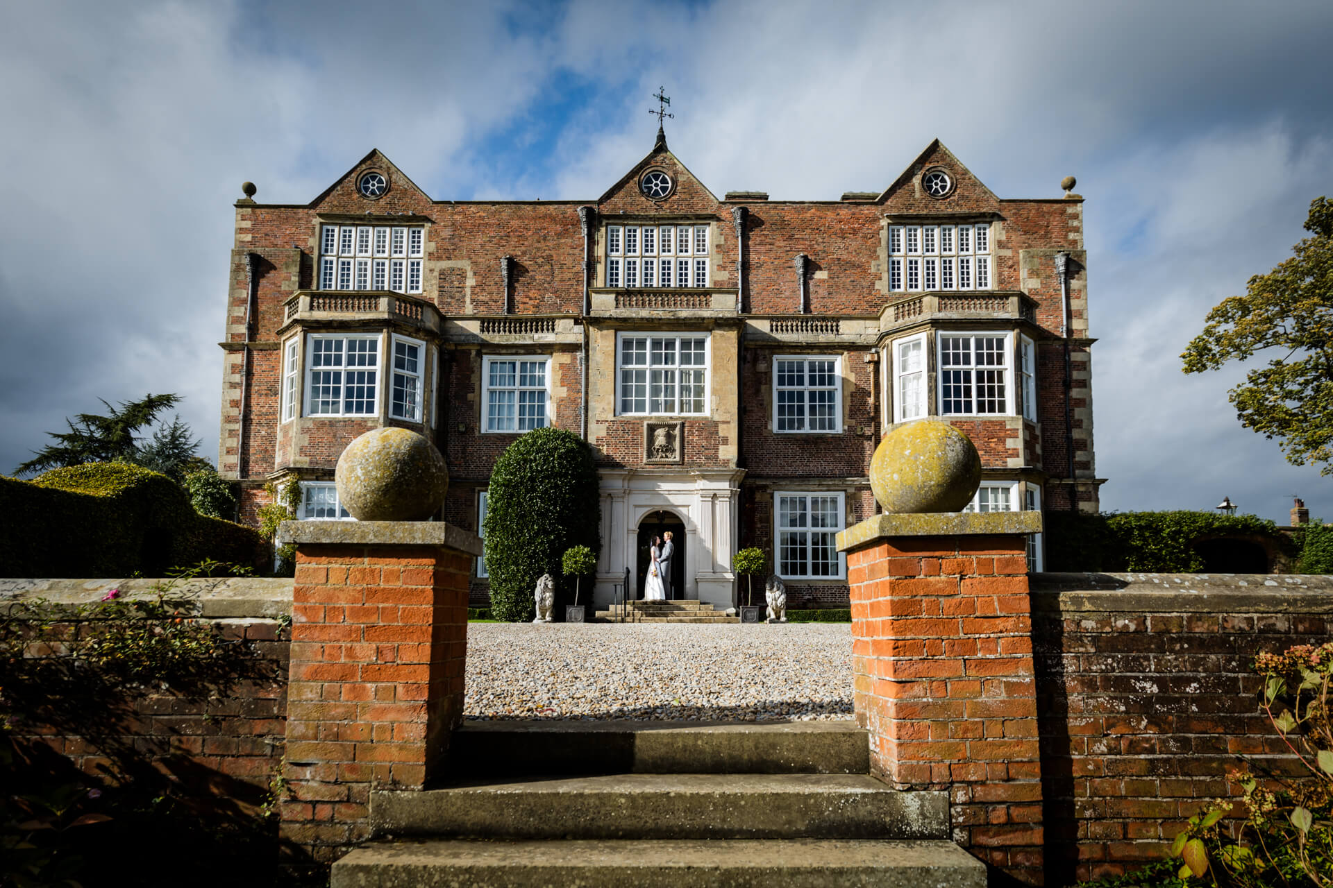 Goldsborough Hall manor house with wedding couple at entrance