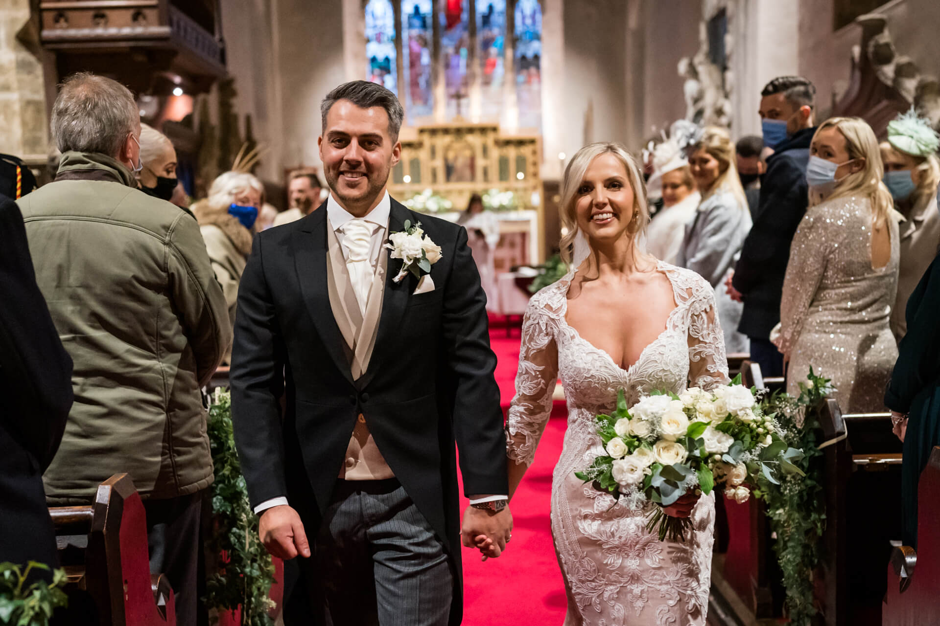 Bride and groom walking down the aisle post-ceremony.