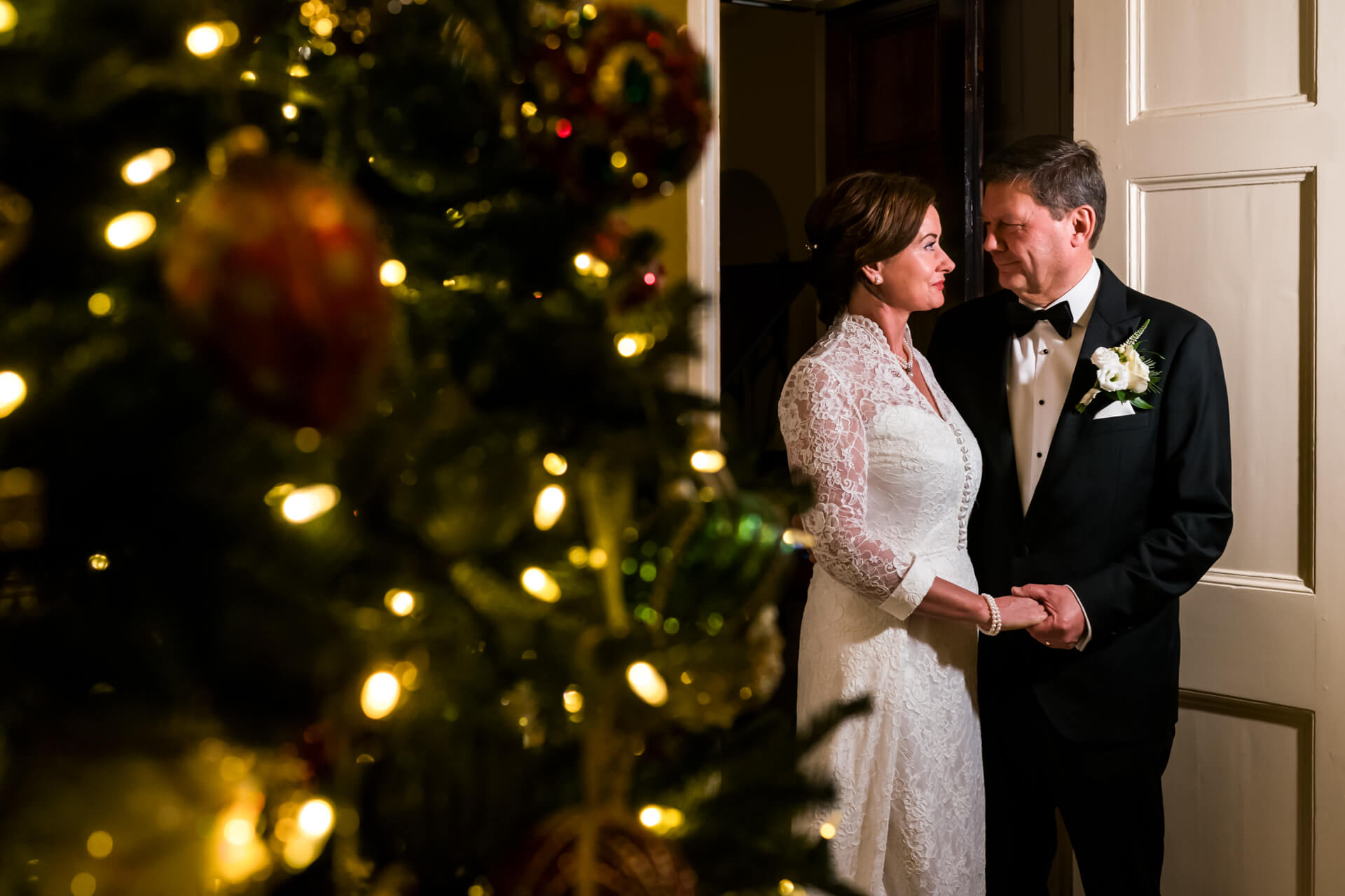 Couple holding hands at Christmas wedding