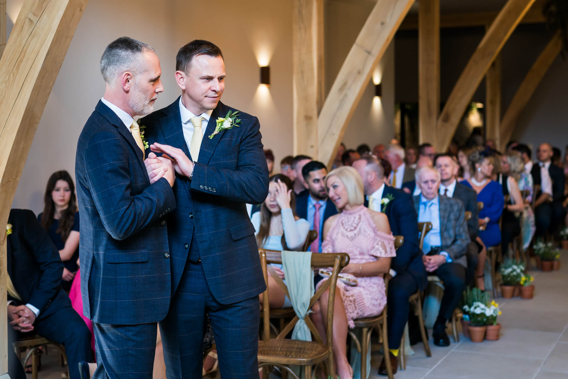 Groom and best man at the top of the wedding aisle