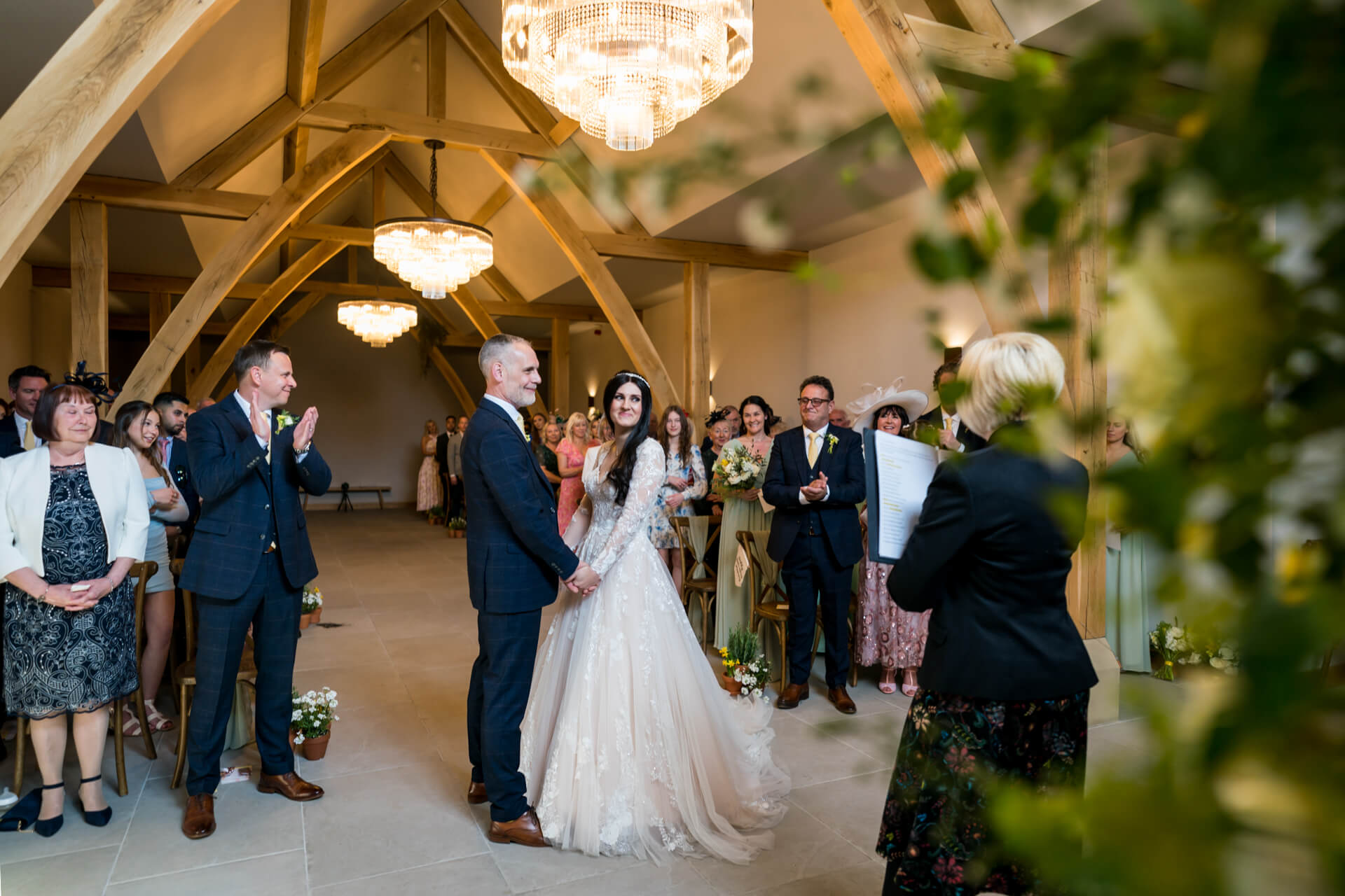 Wedding ceremony in elegant barn venue.