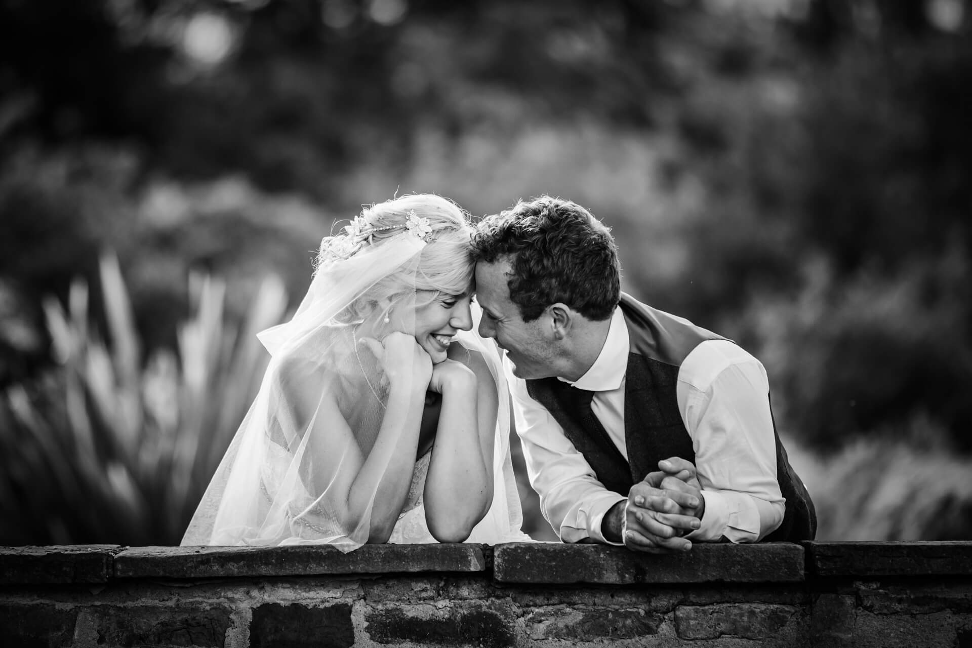 Bride and groom sharing intimate moment outdoors at Hornington Manor