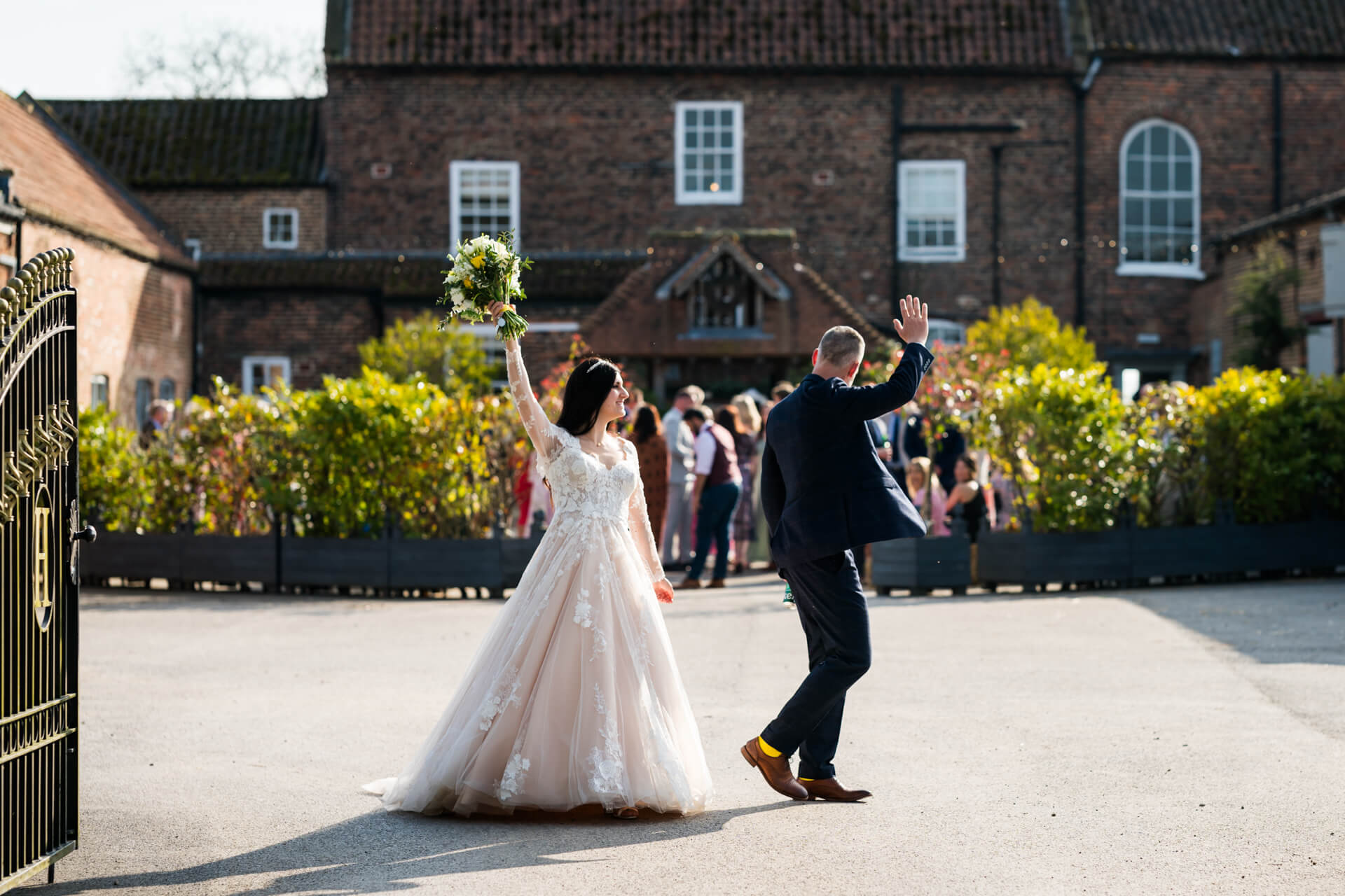 Bride and groom celebrating outside wedding venue
