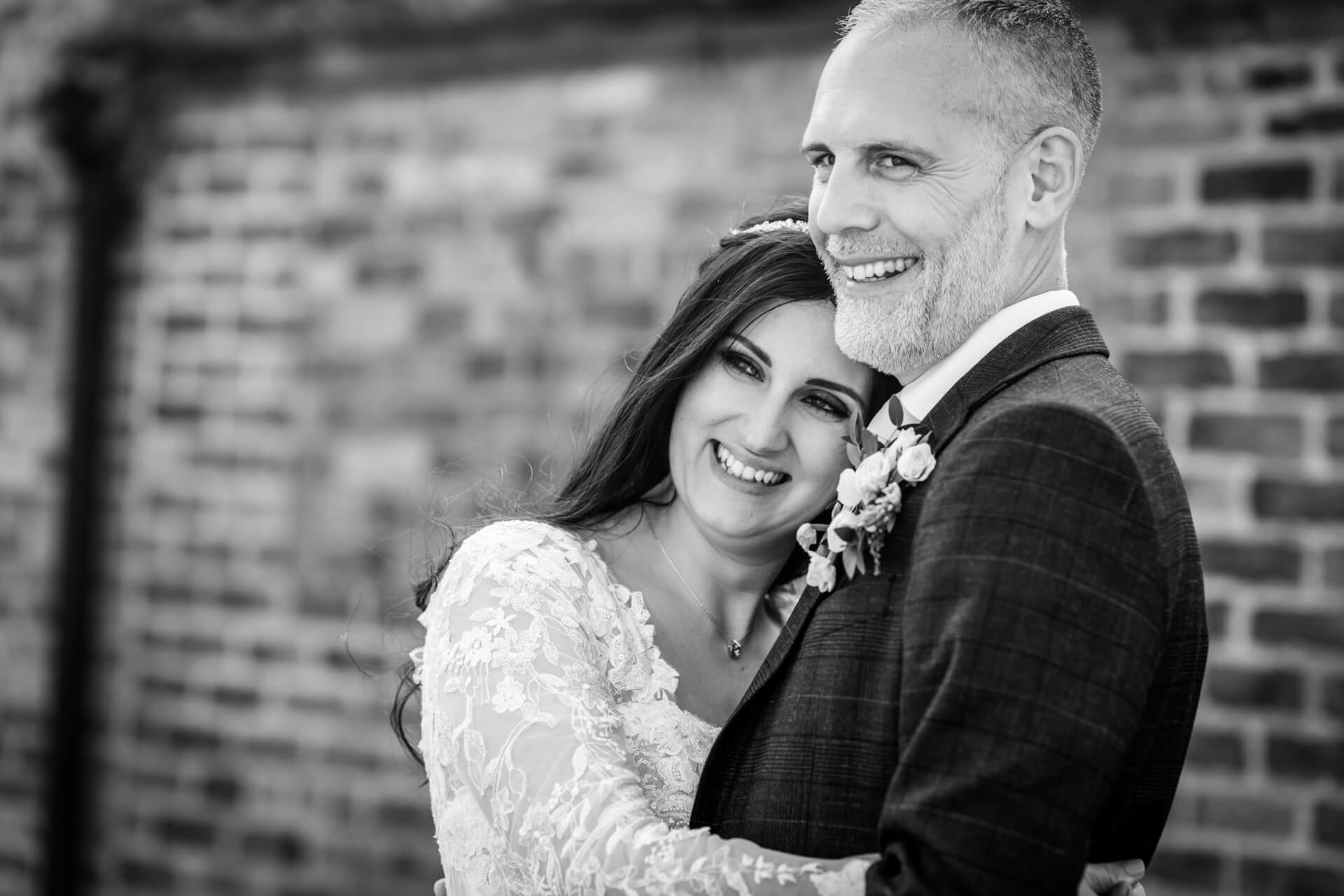 Bride and groom smiling, black and white photo