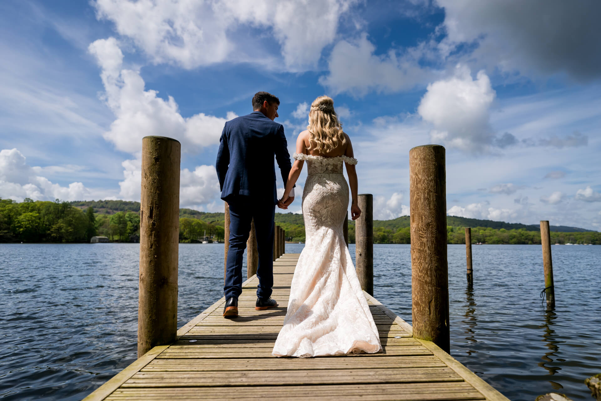Bride and groom walking on lakeside dock at the Towhead Estate