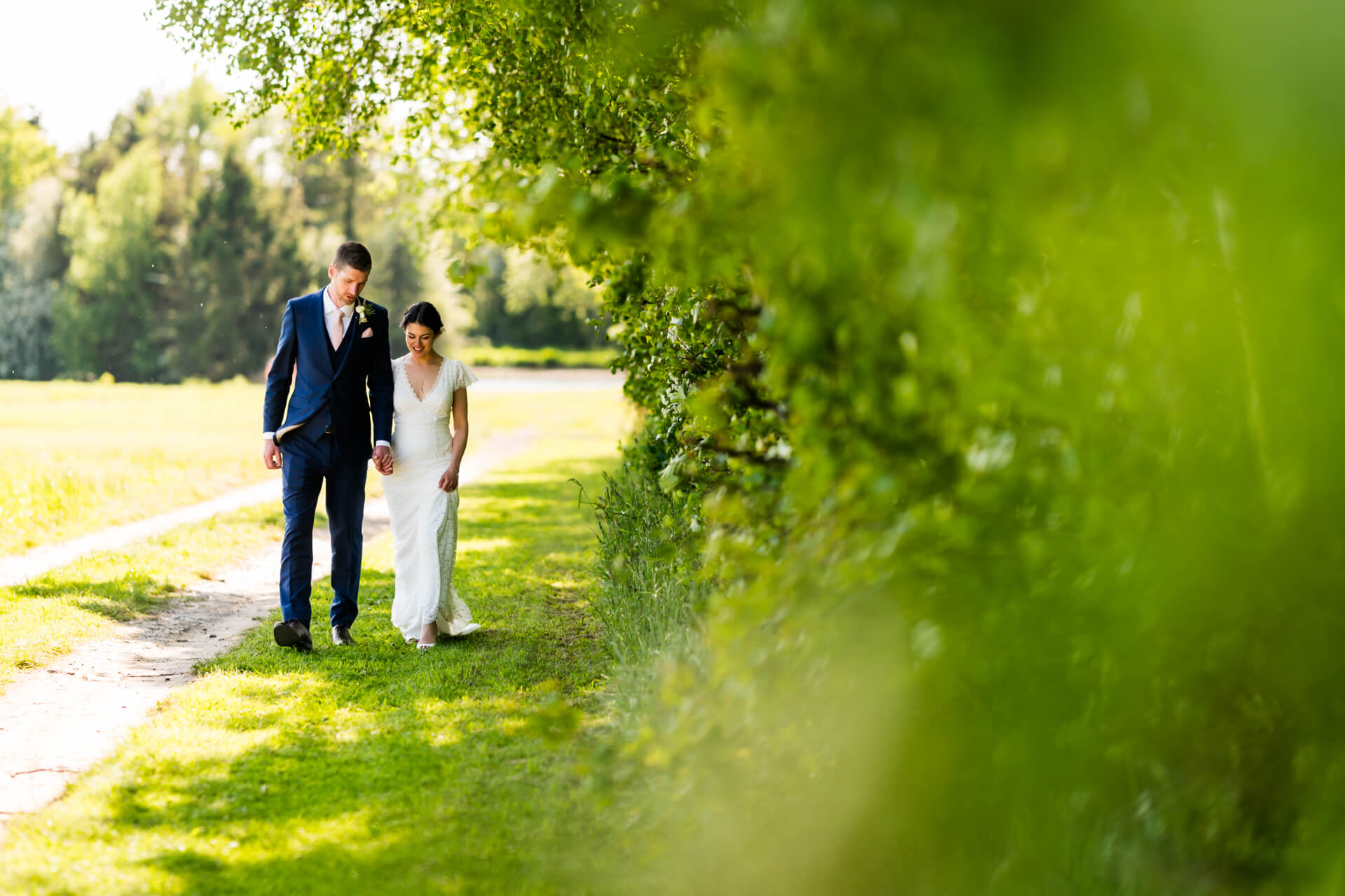 Couple walking on park path at wedding at Low Osgoodby Grange