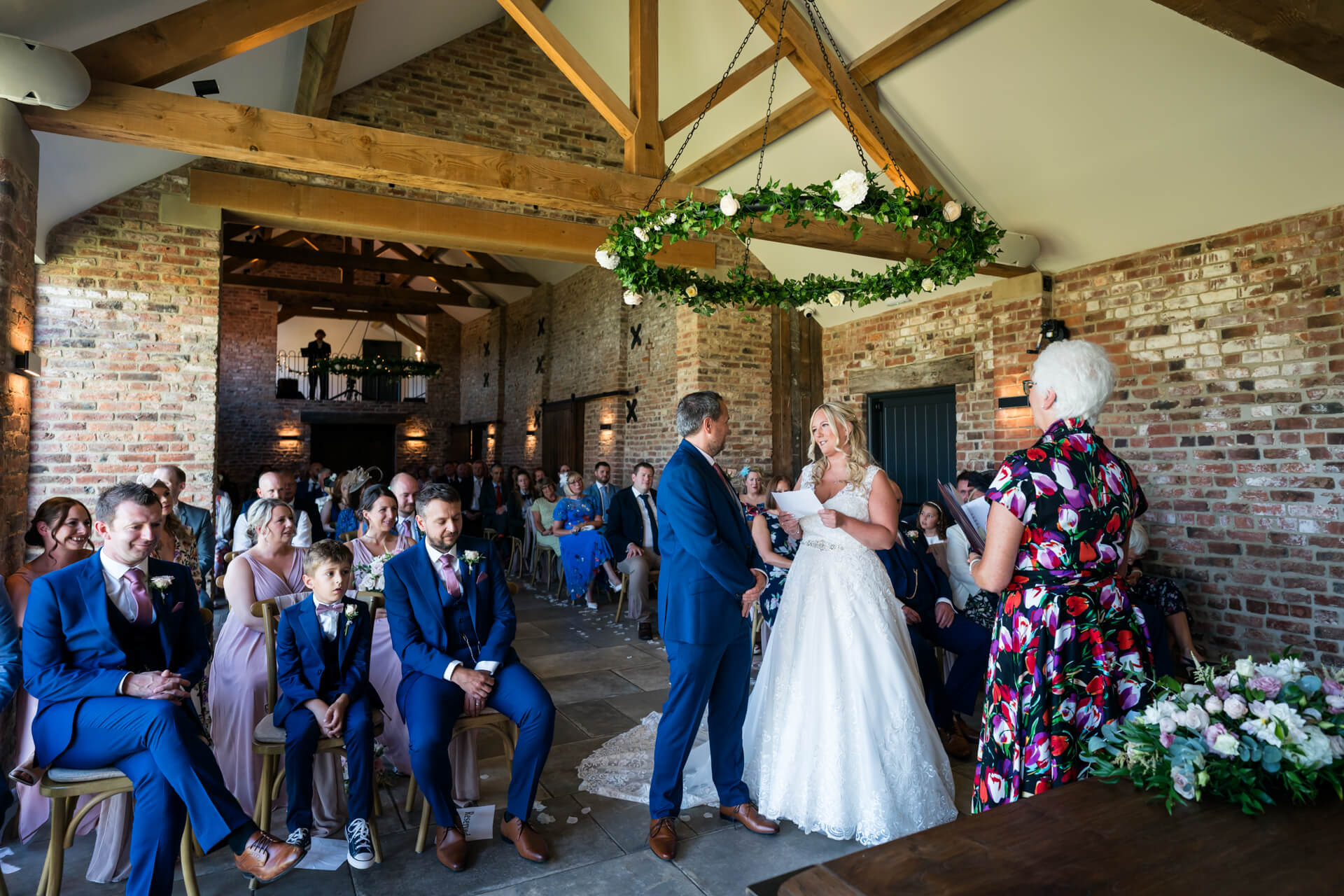 Wedding ceremony in rustic barn venue.