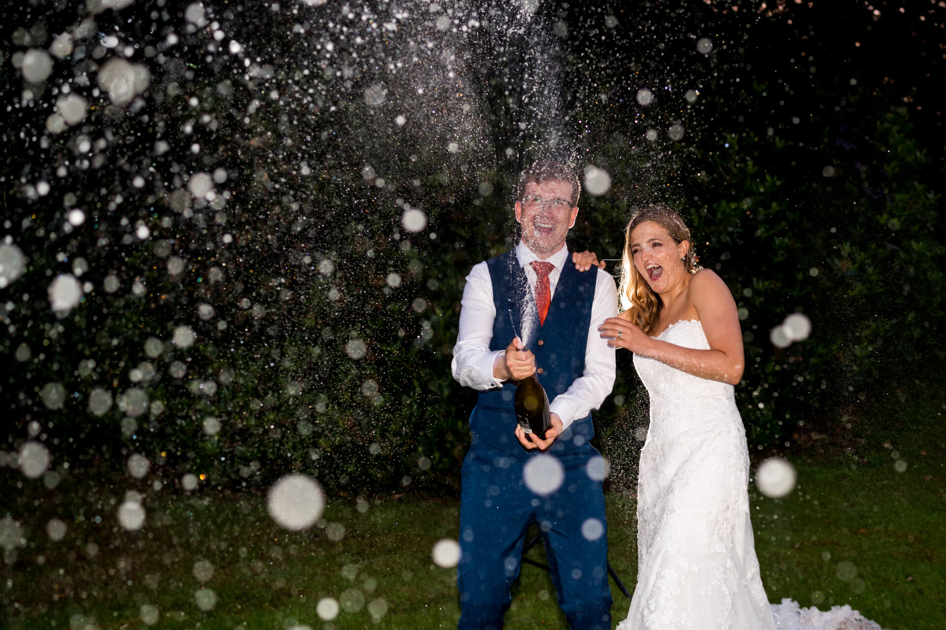 Couple celebrating with a champagne pop at the Townhead Estate