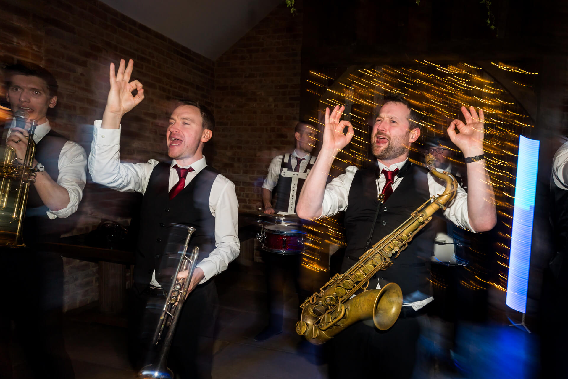 Musicians performing energetically at a lively wedding reception