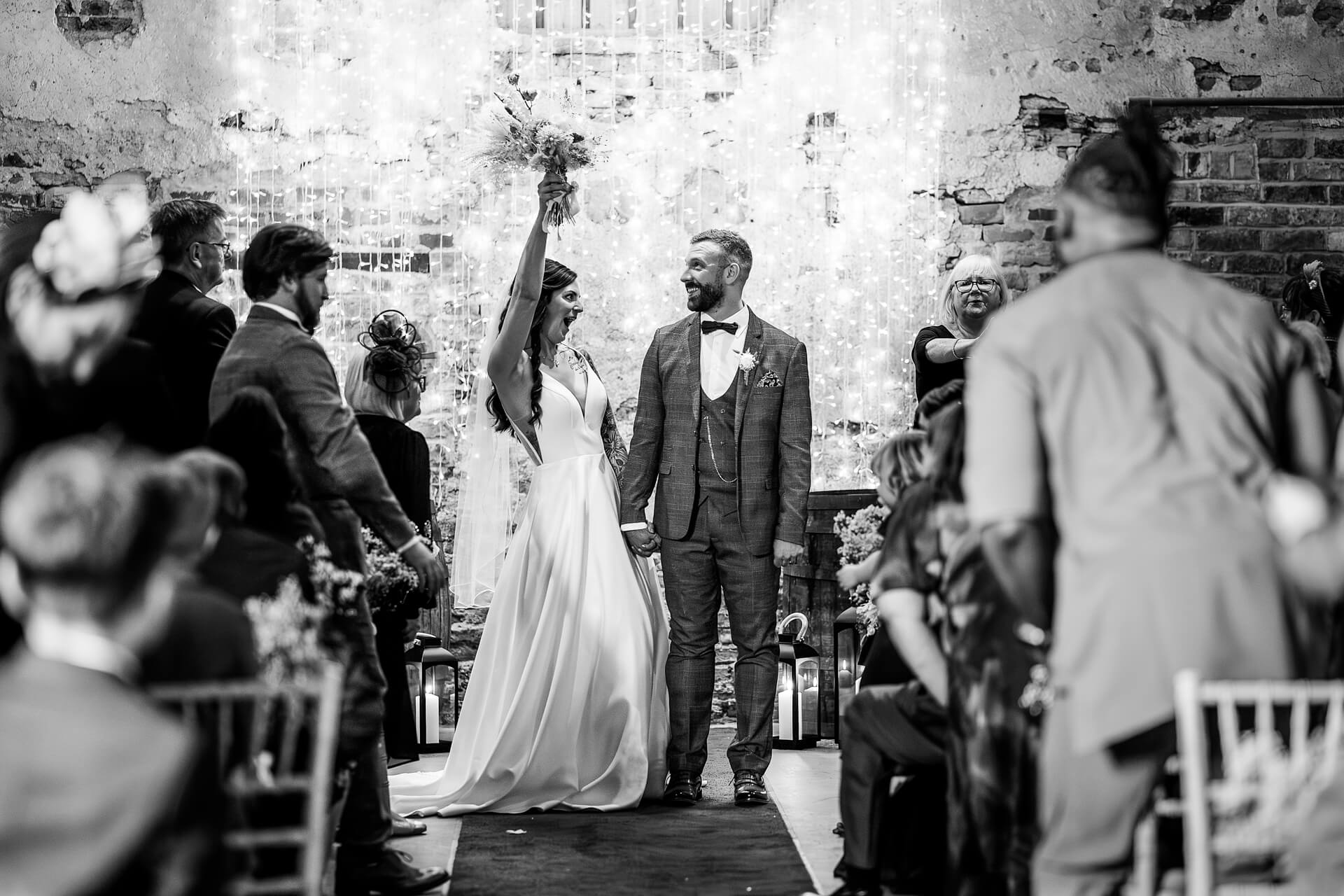 Newlyweds celebrating with guests at The Normans wedding barn