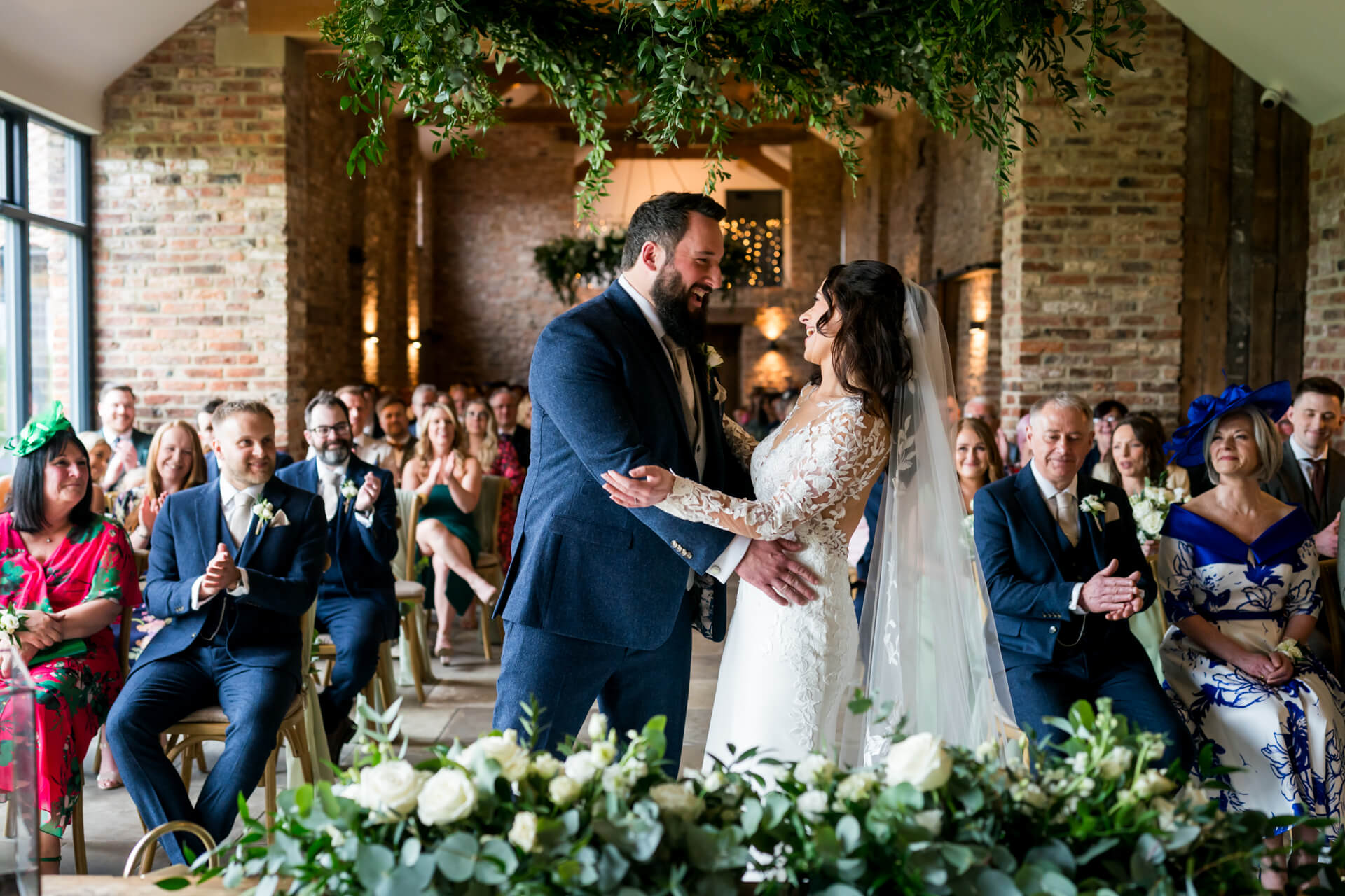 Bride and groom exchanging vows at Thirsk Lodge barns