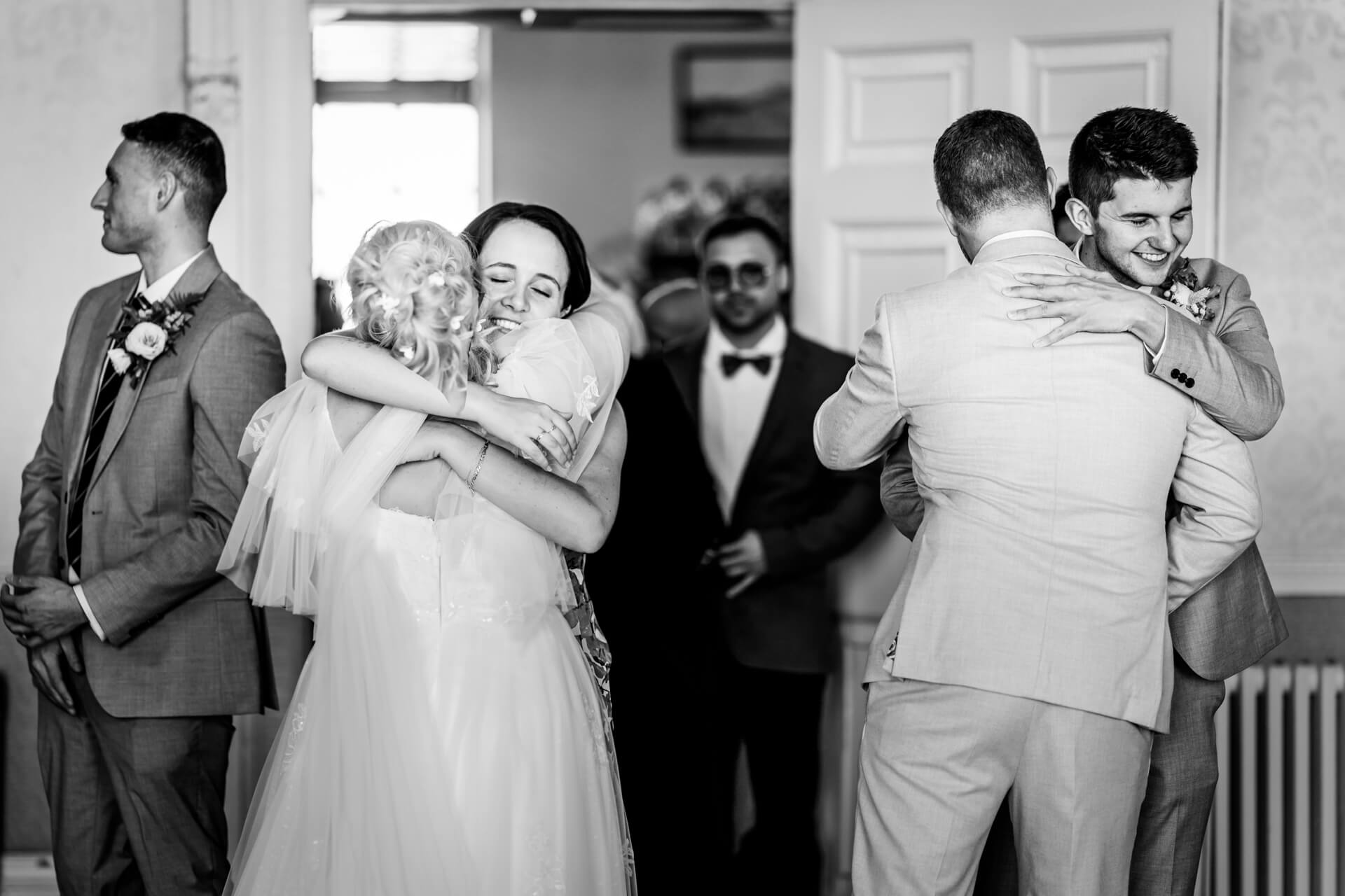 Joyful wedding hugs in black and white photo