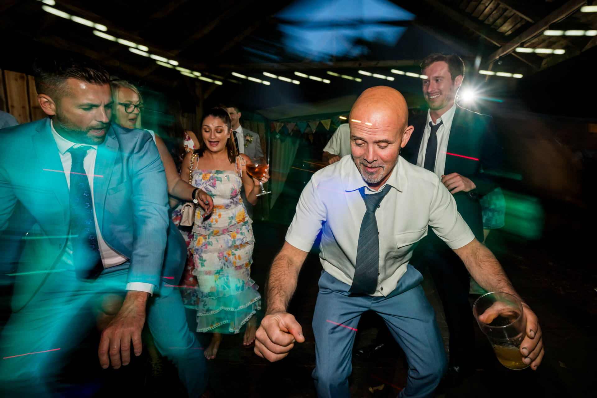 Guests dancing joyfully at a lively wedding reception