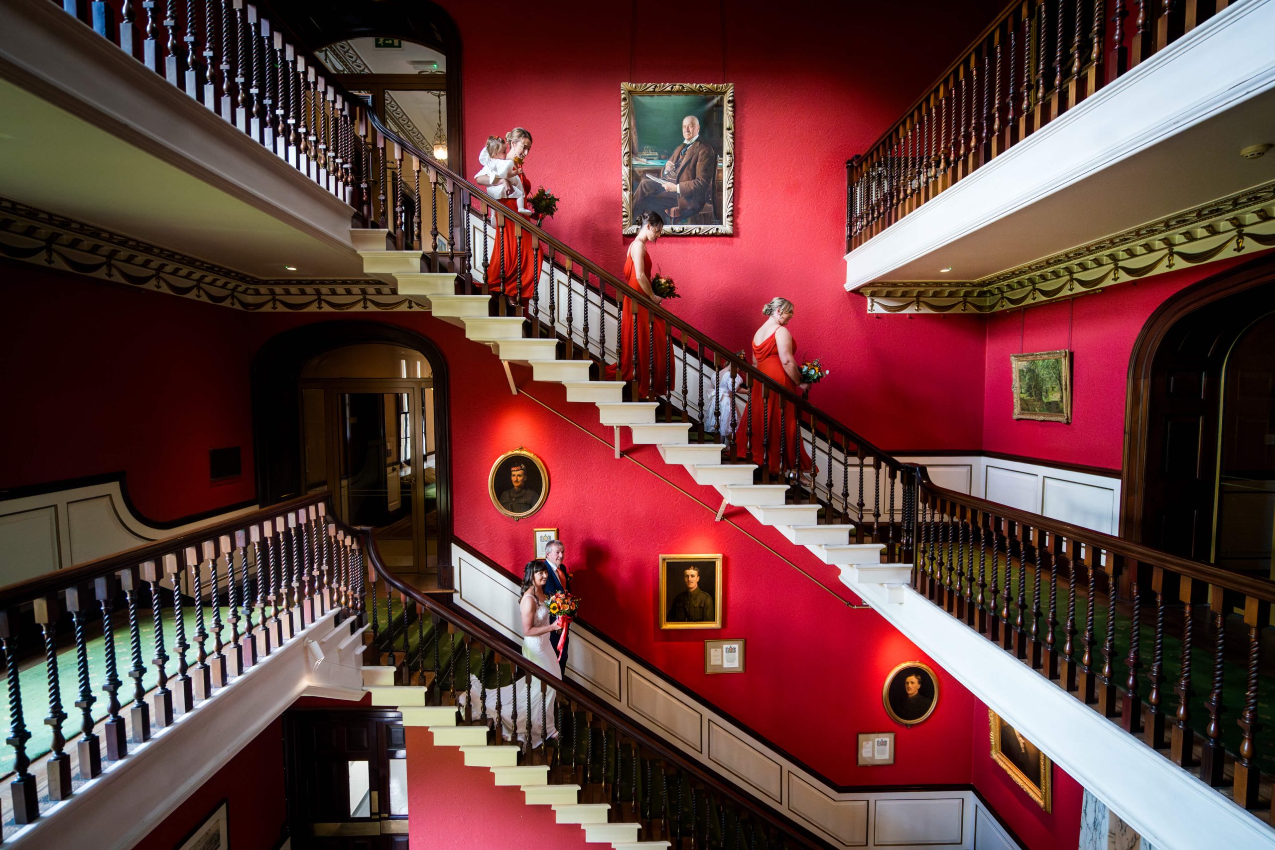 Elegant staircase with people in formal attire