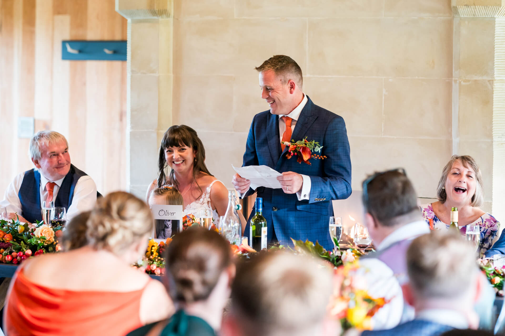 Groom giving joyful speech at wedding reception