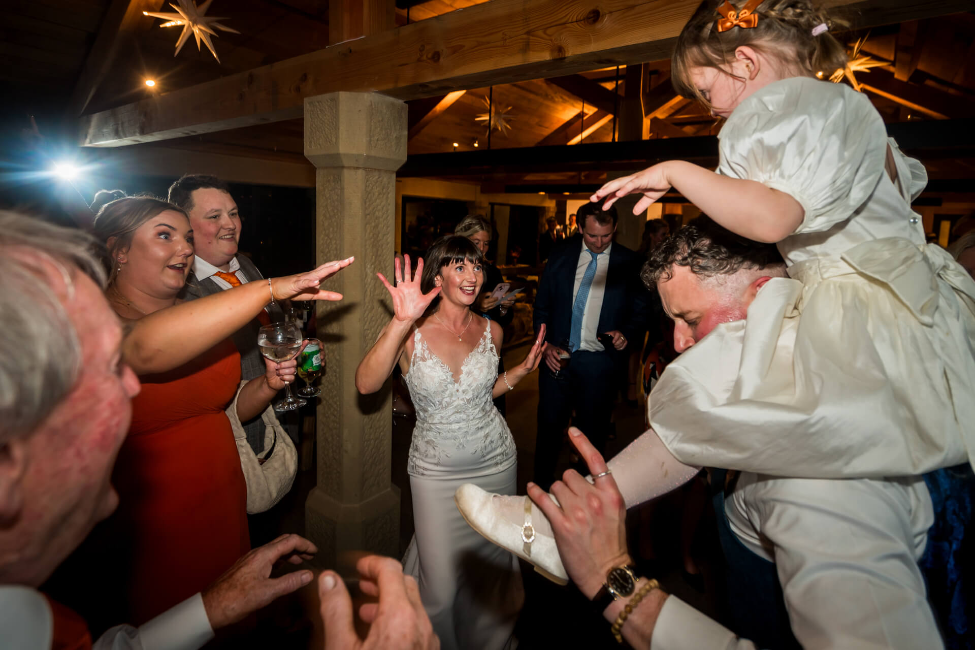Joyful wedding dance with bride, guests, and child