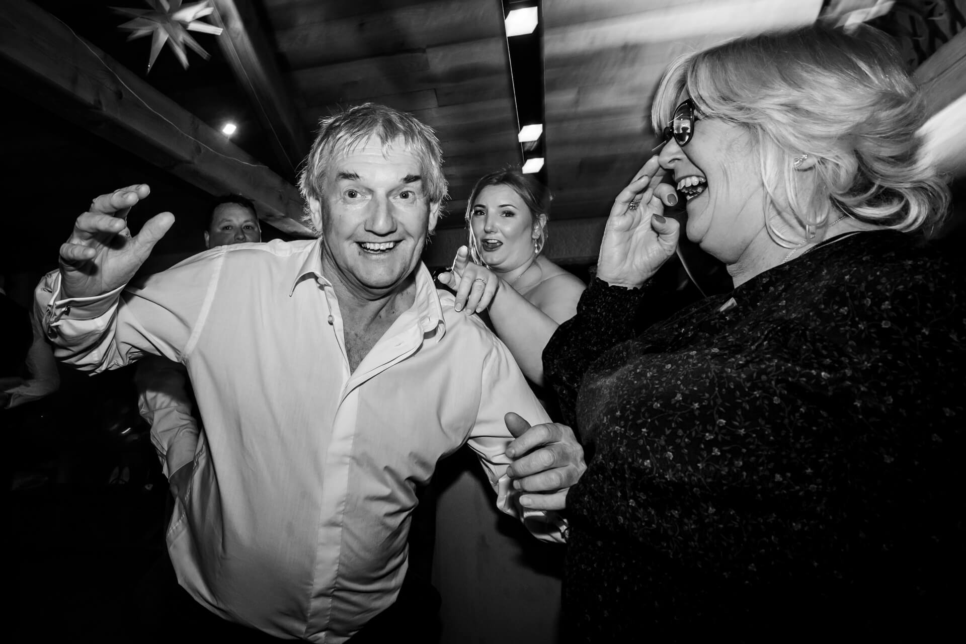 Joyous dance at lively party in black and white