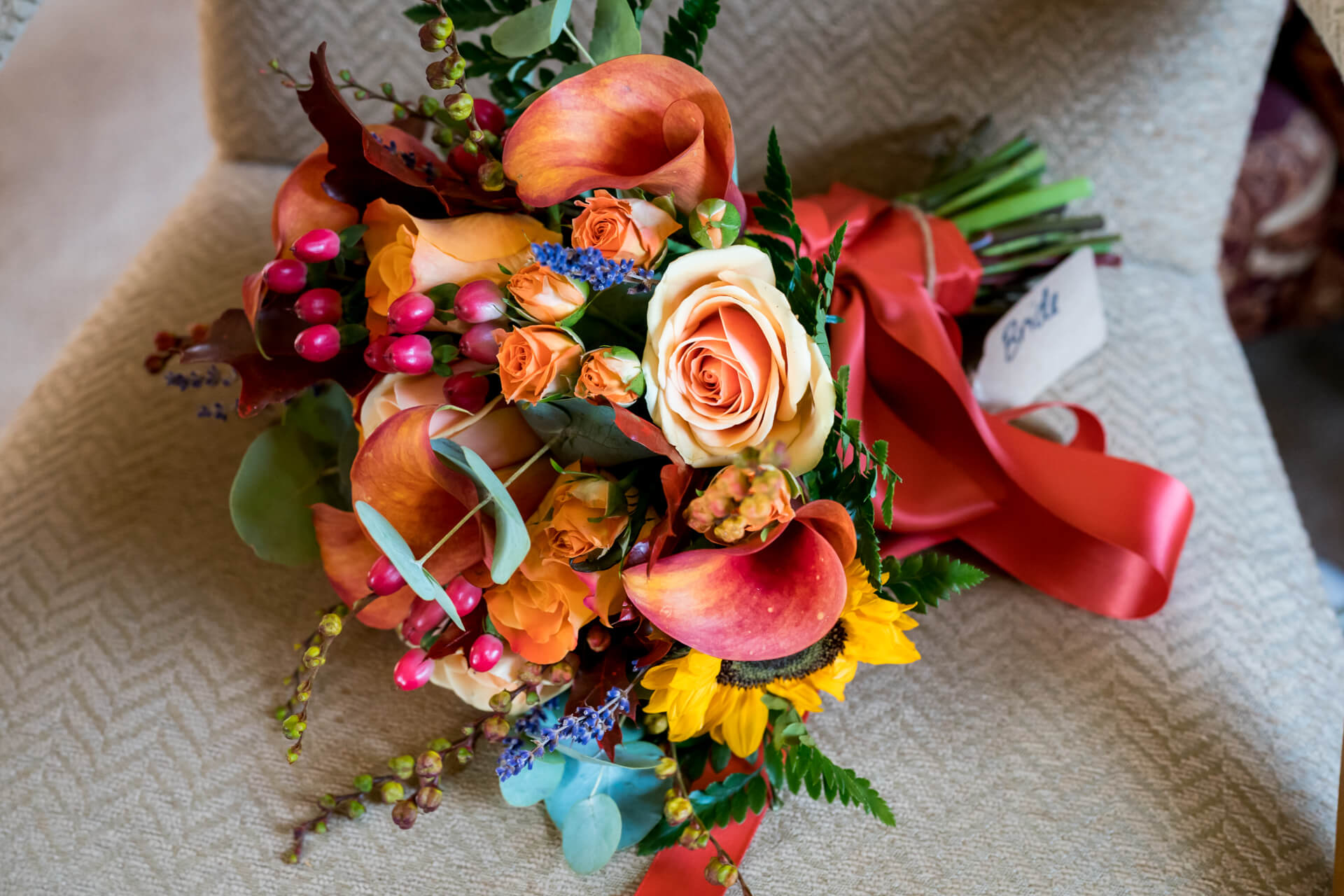 Vibrant bridal bouquet with autumn tones and ribbon