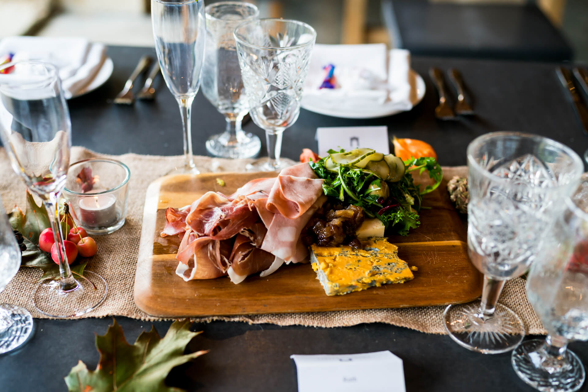 Elegant dining setup with charcuterie board and glasses