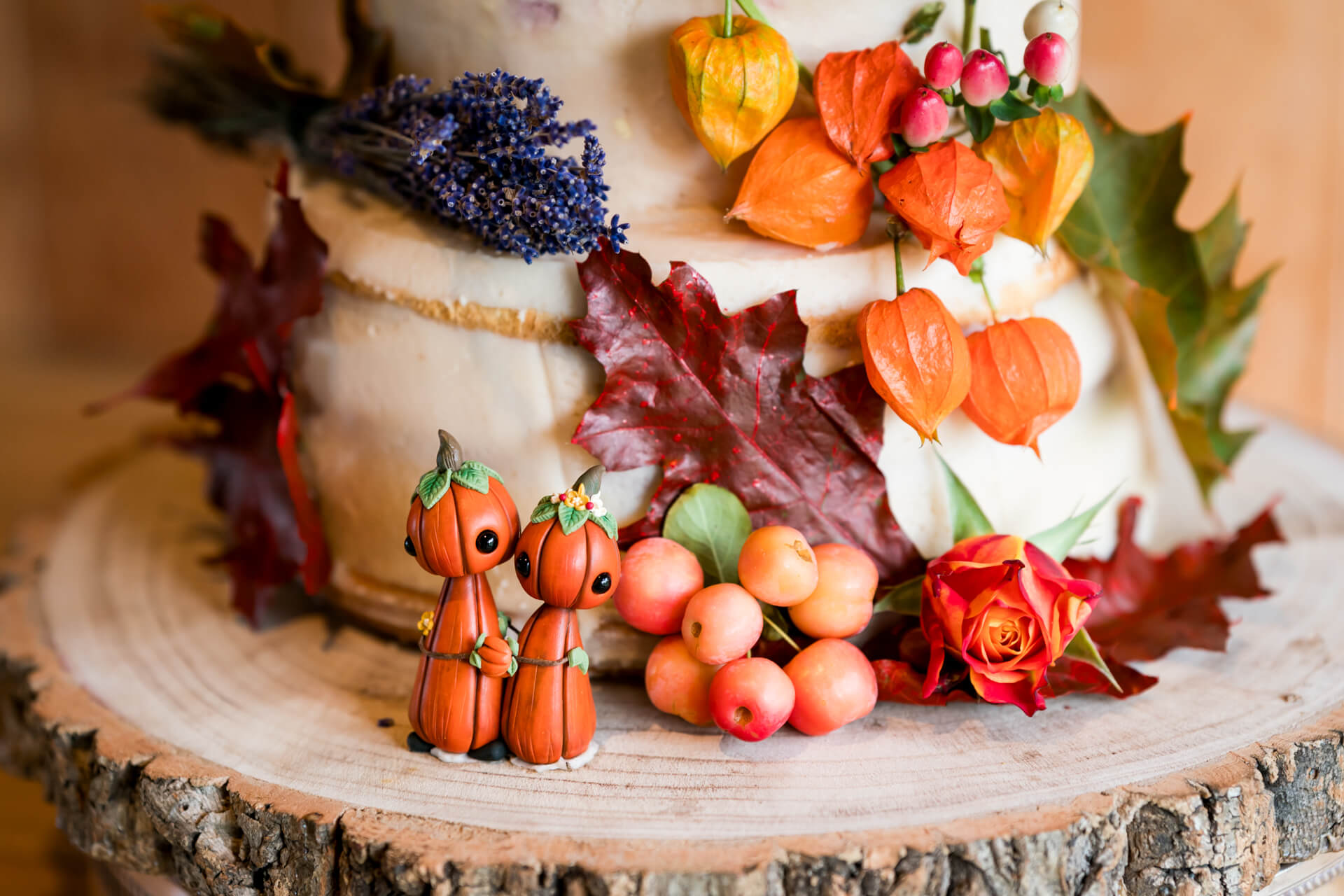 Autumn-themed cake with decorative pumpkin figures