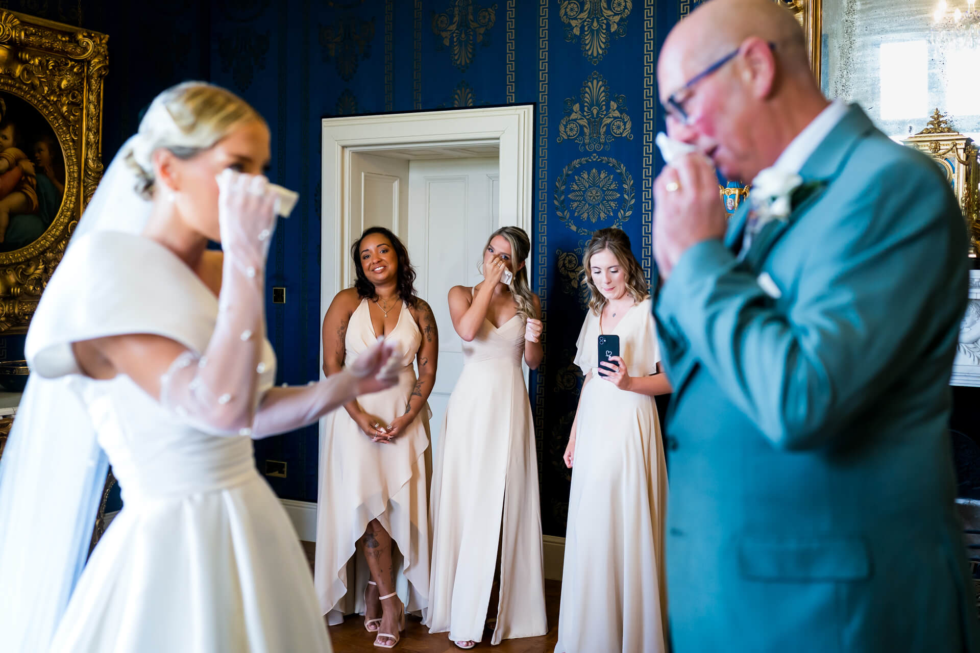 Emotional wedding moment in elegant blue room