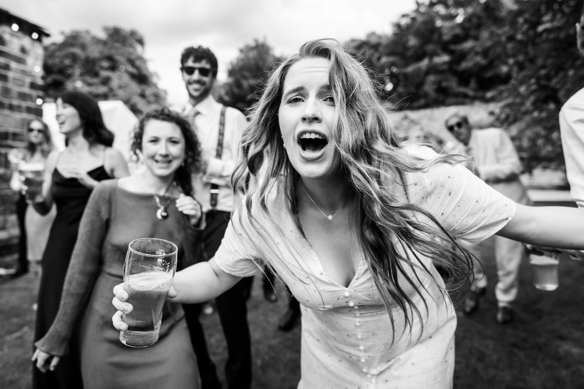 Joyful woman singing at outdoor party