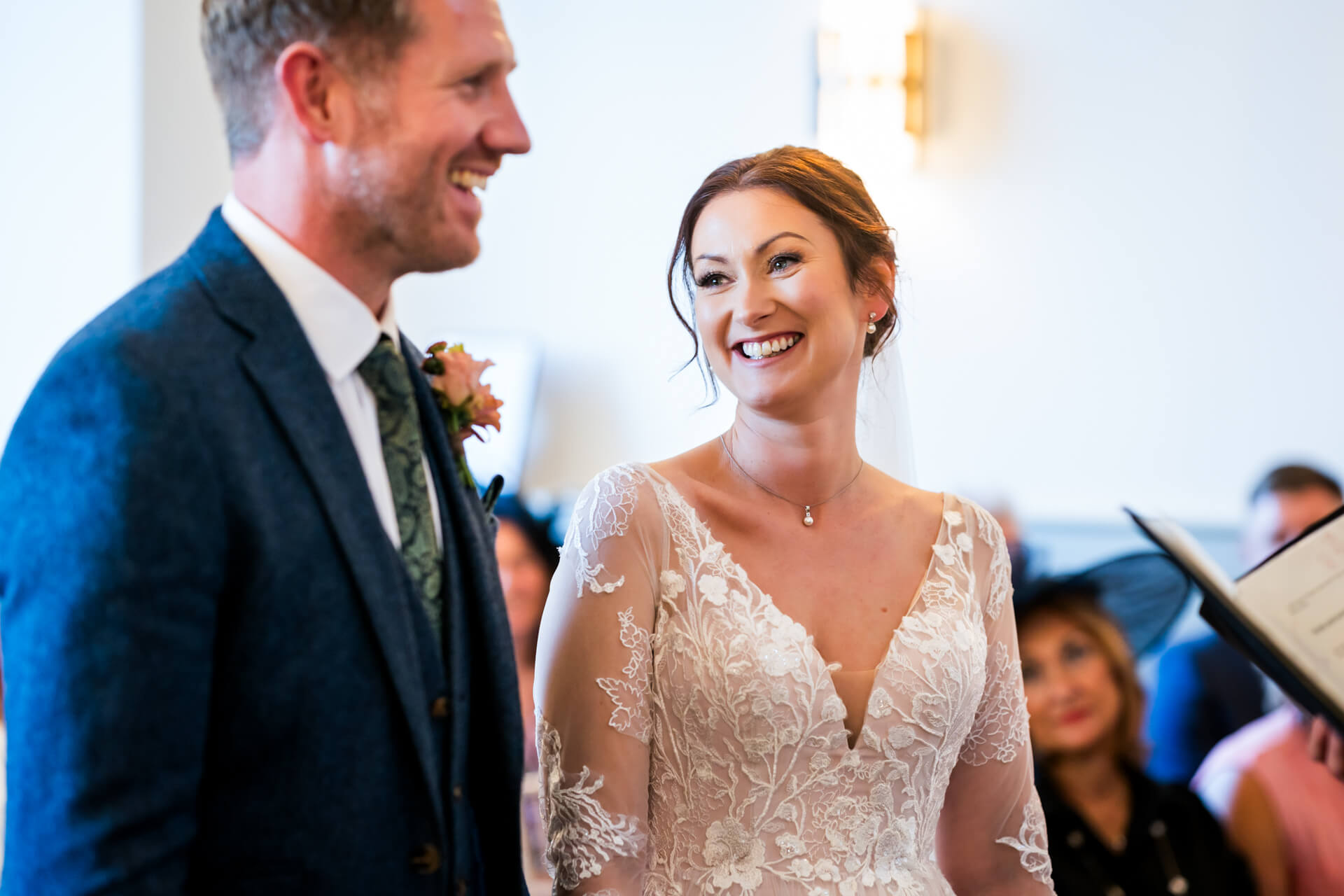 Joyful bride and groom smiling during wedding ceremony