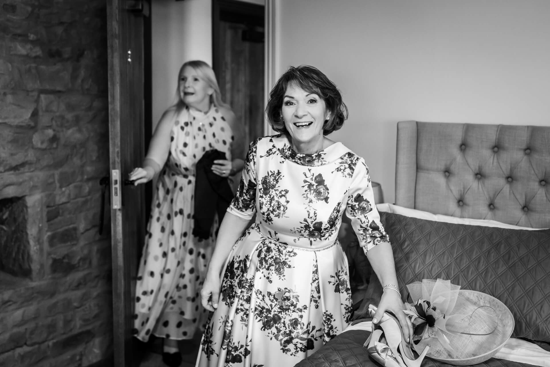 Two women in stylish dresses enjoying a festive occasion
