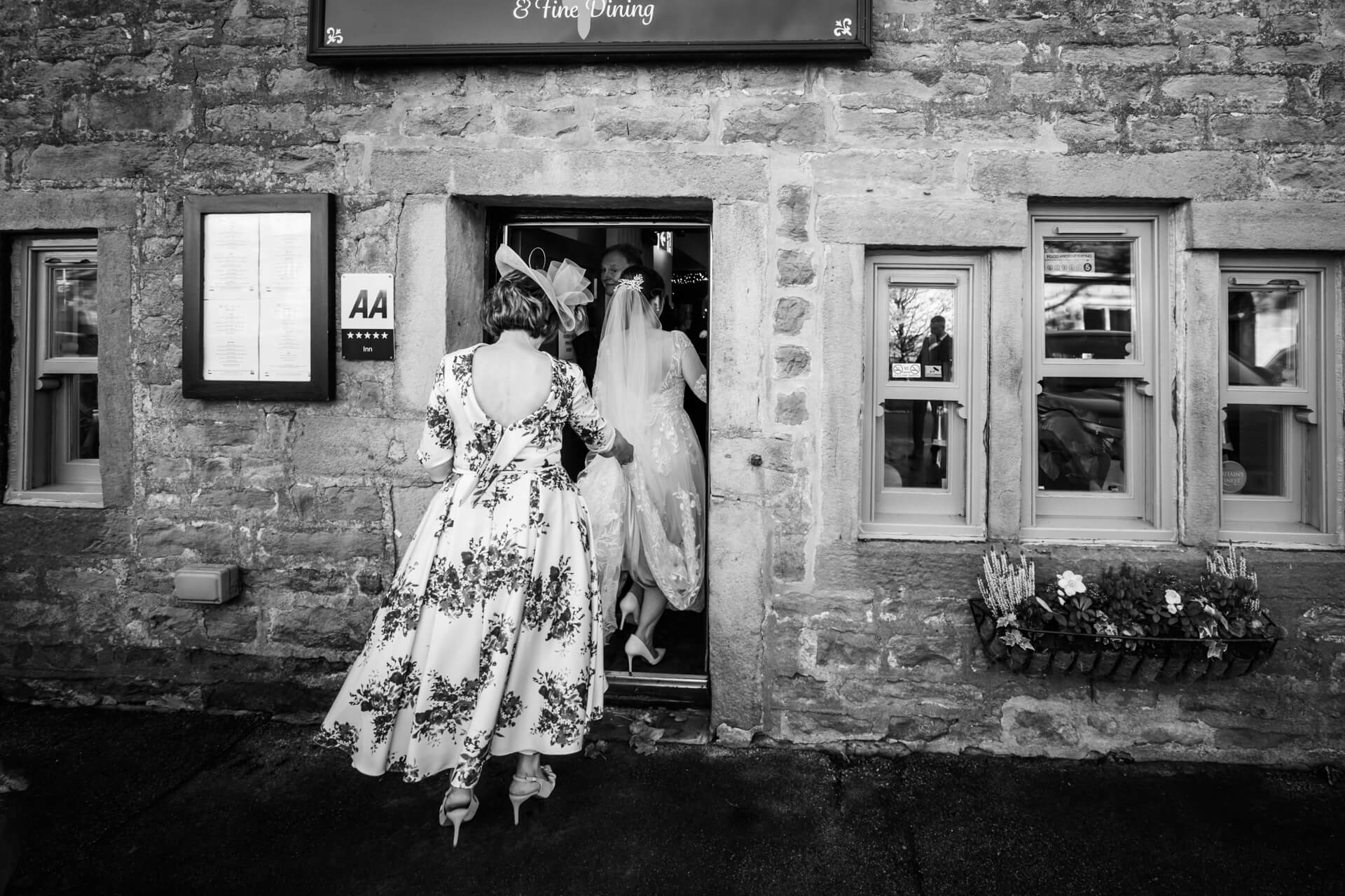 Bride entering a restaurant for dining in a rural setting