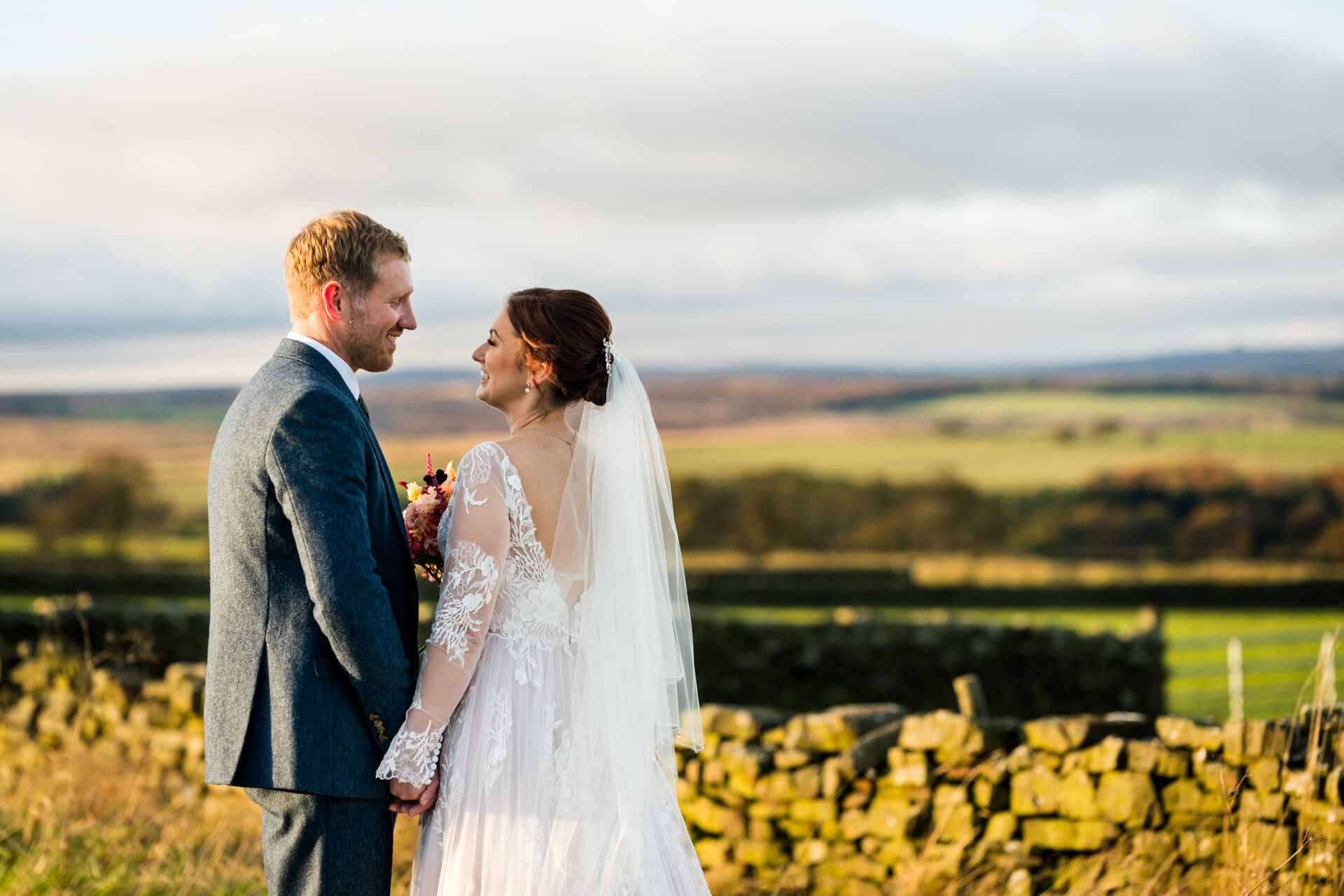Bride and groom smiling in Yorkshire countryside