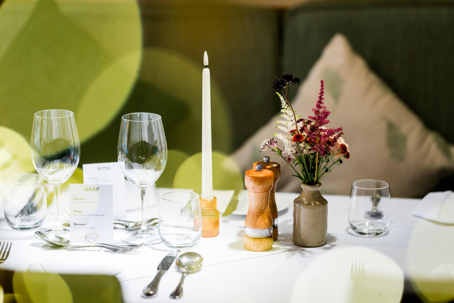 Elegant dinner table setting with name cards and flowers