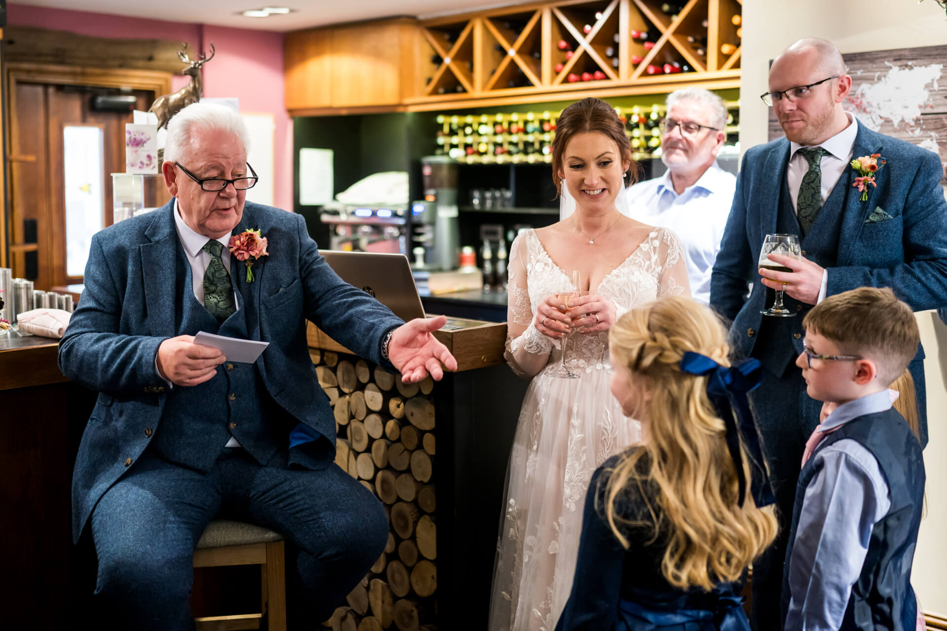 Elderly man giving speech at wedding reception
