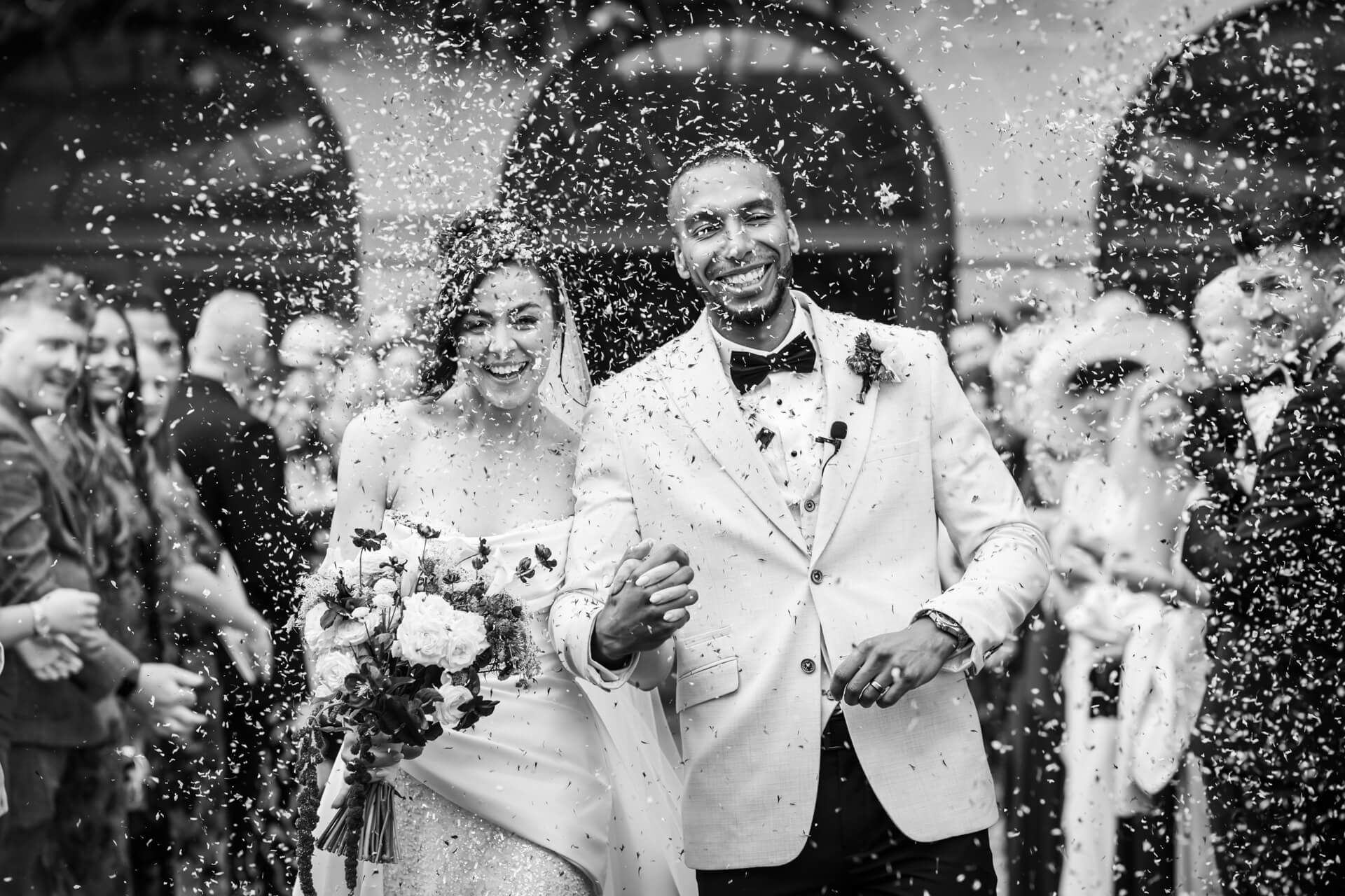 Happy couple celebrate wedding with confetti