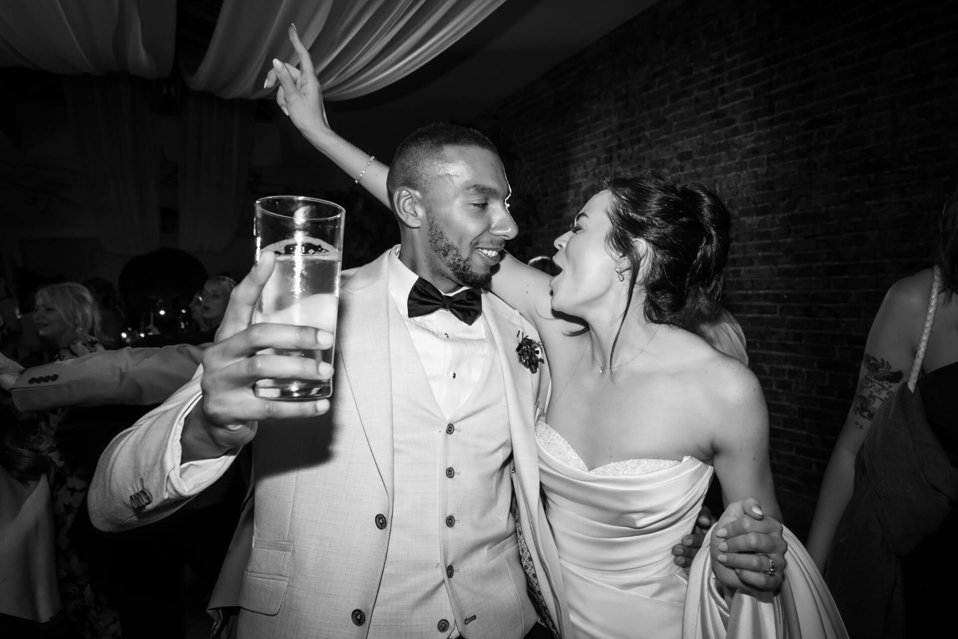Happy couple celebrating at a wedding reception.