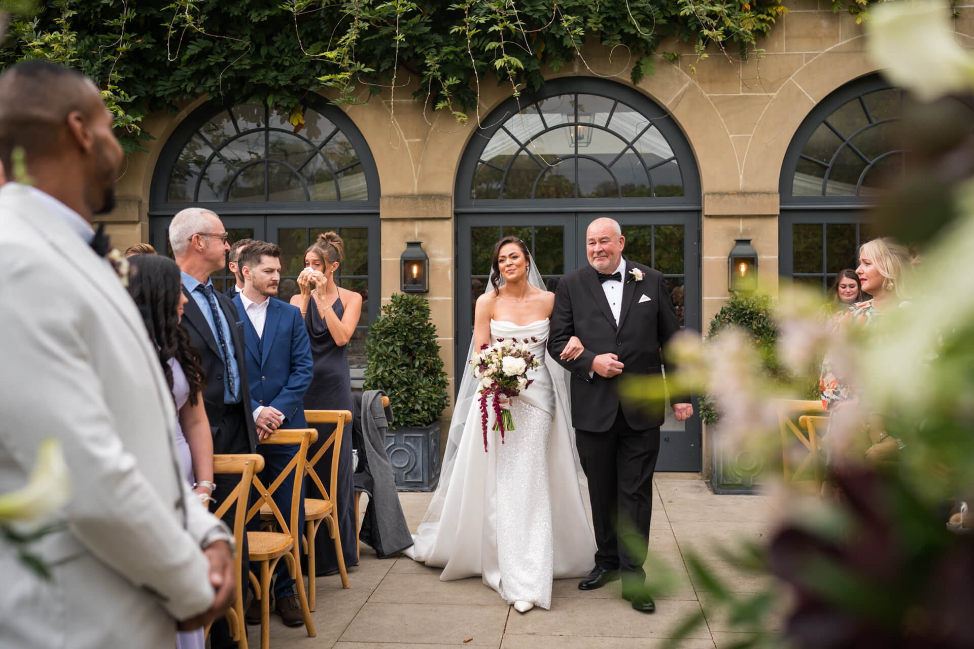 Bride walking down aisle with father at wedding