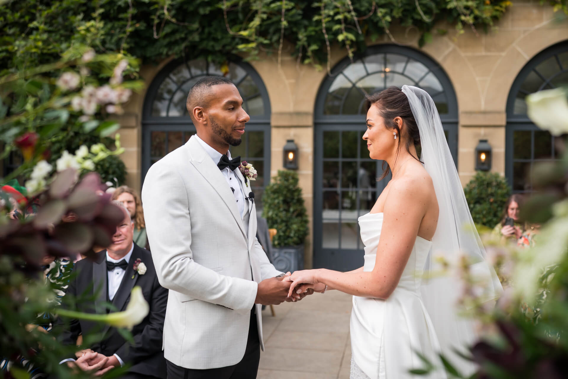 Bride and groom exchanging vows outdoors